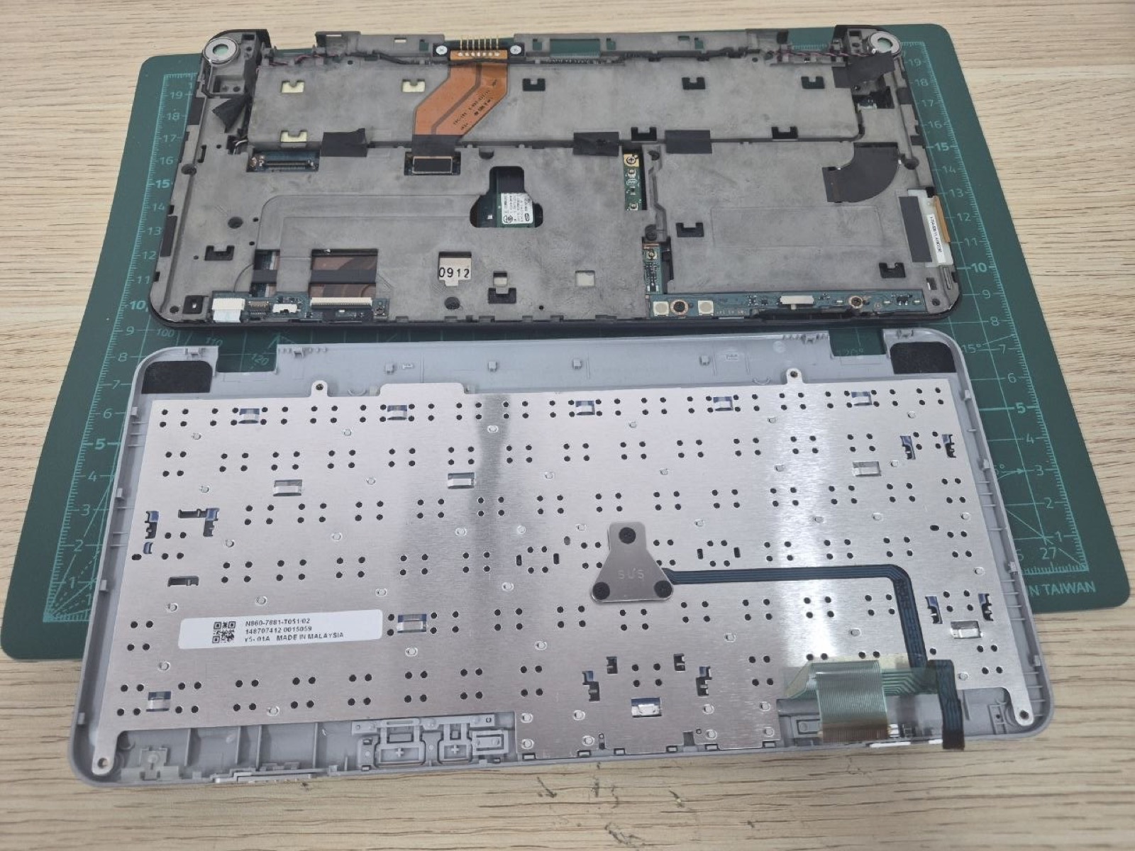 Sony VAIO P keyboard deck underside and lower chassis showing the original ribbon cable path