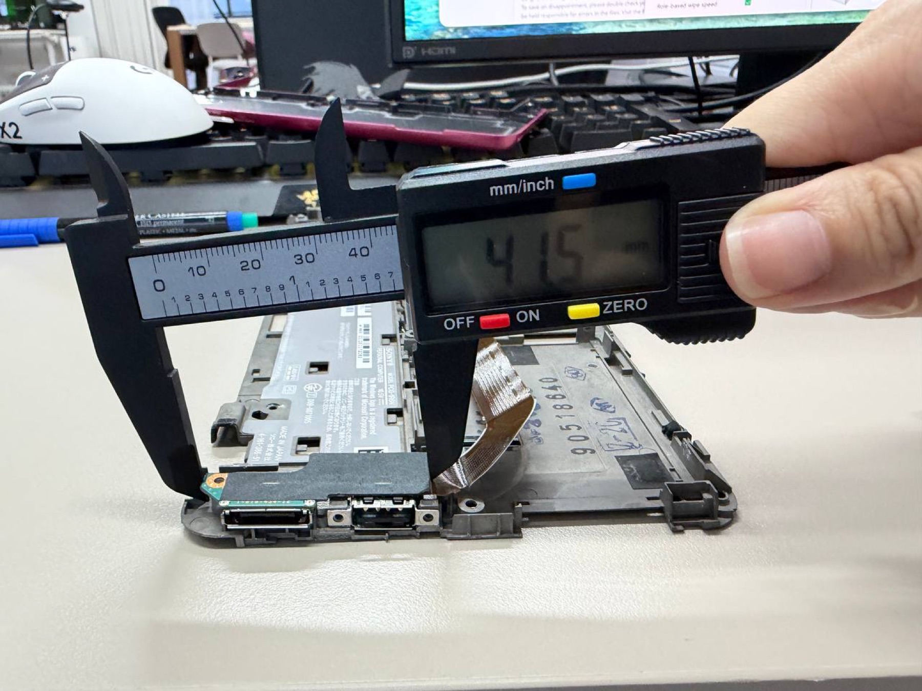 Digital caliper measuring a side port pocket inside the Sony VAIO P lower chassis