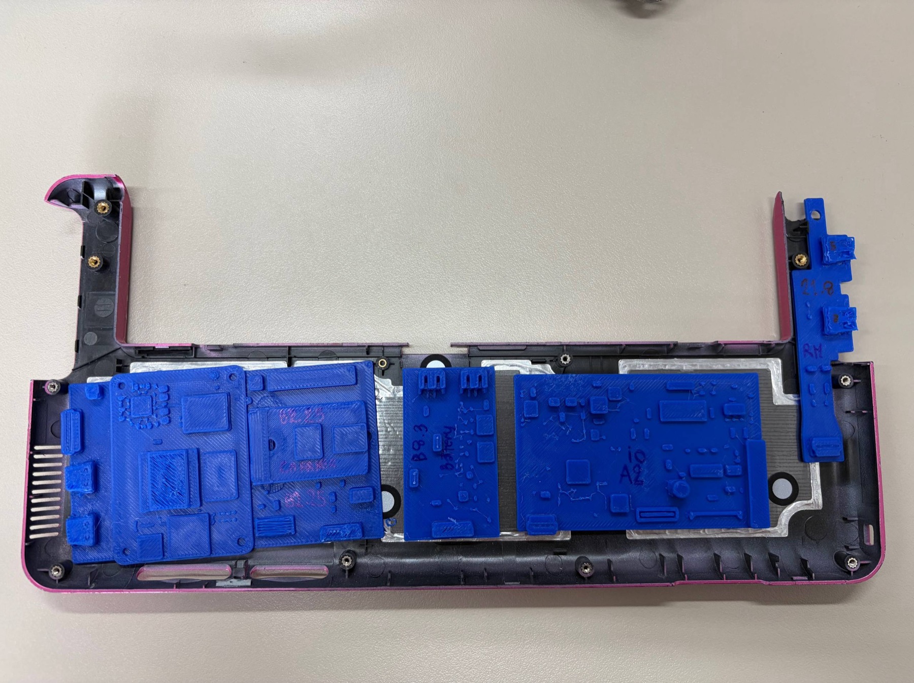 Blue printed PCB mockups placed inside the Sony VAIO P lower shell for CM5 carrier and side-board fit checks